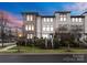 Modern three-story townhome with stone accents and landscaped grounds at 305 Ideal Way, Charlotte, NC 28203