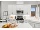 Modern kitchen features white cabinets, gas range, and quartz countertops at 305 Ideal Way, Charlotte, NC 28203