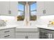 Modern kitchen features white cabinets, quartz countertops, and a farmhouse sink at 305 Ideal Way, Charlotte, NC 28203