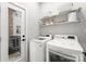 Laundry room with side-by-side washer and dryer, and built-in shelving at 305 Ideal Way, Charlotte, NC 28203