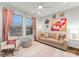 Bright living room with beige sofa, pink accents, and large art pieces at 305 Ideal Way, Charlotte, NC 28203