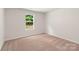 Well-lit bedroom featuring a window with a view of nature at 3258 Clover Valley Dr, Gastonia, NC 28052