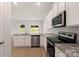 Kitchen with island, granite countertops, and stainless steel appliances at 3258 Clover Valley Dr, Gastonia, NC 28052