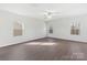 Bright, neutral living room featuring multiple windows and luxury vinyl flooring at 3258 Maple Ridge Dr, Gastonia, NC 28052