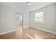 Bright living room featuring hardwood floors, freshly painted white walls, and lots of natural light at 3724 Commonwealth Ave, Charlotte, NC 28205