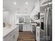 Modern kitchen with white cabinets, stainless steel appliances and an island at 3731 S Tryon St, Charlotte, NC 28217