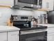 Close-up of kitchen stovetop with modern range and under-cabinet lighting at 3731 S Tryon St, Charlotte, NC 28217