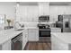 White kitchen features stainless steel appliances and a gas cooktop at 3731 S Tryon St, Charlotte, NC 28217