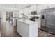 Modern kitchen with white cabinets, stainless steel appliances, and island at 3731 S Tryon St, Charlotte, NC 28217