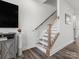 Modern staircase with simple design, wooden handrail and baby gate at 3731 S Tryon St, Charlotte, NC 28217