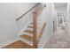 Wooden staircase with white railings in hallway at 3731 S Tryon St, Charlotte, NC 28217