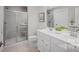 Bathroom with double vanity, shower, and neutral tile flooring at 421 Grandiflora Ave # 0084, Lancaster, SC 29720