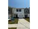 Charming new construction townhome featuring a one-car garage and welcoming front lawn at 5054 Kellaher Pl, Charlotte, NC 28216