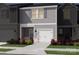 Gray two-story townhome with white garage door and landscaping at 5054 Kellaher Pl, Charlotte, NC 28216