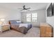 Comfortable bedroom with ceiling fan and dresser at 5066 Summer Surprise Ln, Charlotte, NC 28215