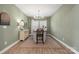 Dining room features a farmhouse table and light green walls at 5066 Summer Surprise Ln, Charlotte, NC 28215