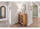 Bright entryway with wood cabinet, mirror, and laminate wood flooring at 5066 Summer Surprise Ln, Charlotte, NC 28215