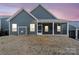 Exterior view of the rear of the home with a screened porch and a backdrop of a colorful sunset at 5066 Summer Surprise Ln, Charlotte, NC 28215