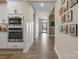 Open hallway with wood-look floors and view into the kitchen at 5066 Summer Surprise Ln, Charlotte, NC 28215