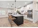 Modern kitchen with white cabinets, island, and stainless steel appliances at 5066 Summer Surprise Ln, Charlotte, NC 28215