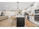 Modern kitchen with white cabinets, large island, and stainless steel appliances at 5066 Summer Surprise Ln, Charlotte, NC 28215