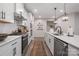 Long kitchen with white cabinets, stainless steel appliances, and an island at 5066 Summer Surprise Ln, Charlotte, NC 28215