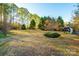 Large backyard with mature trees and landscaping at 5241 Whitewater Dr, Hickory, NC 28601