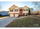 Brick and vinyl two-story house with a two-car garage and landscaped yard at 5241 Whitewater Dr, Hickory, NC 28601