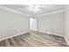 Spacious bedroom with wood-look floors and ceiling fan at 5811 Rocky Mount Ct, Charlotte, NC 28214