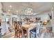 Bright dining area with wood table and chairs, open to the kitchen and living room at 6141 Russo Ct, Lancaster, SC 29720