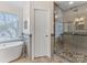 Modern bathroom with walk-in shower and soaking tub at 616 N Oak Dr, Huntersville, NC 28078