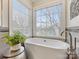 Relaxing bathroom with freestanding tub and large window at 616 N Oak Dr, Huntersville, NC 28078