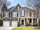 Gray two-story house with black shutters, two-car garage, and manicured lawn at 616 N Oak Dr, Huntersville, NC 28078