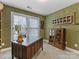 Home office with built-in shelving and wood desk at 616 N Oak Dr, Huntersville, NC 28078