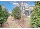 Backyard featuring stone pathway, mature trees, and a screened porch at 6248 Raven Rock Dr, Denver, NC 28037