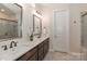 Bathroom featuring double vanity with framed mirrors, modern lighting, and a glass-enclosed shower at 6248 Raven Rock Dr, Denver, NC 28037