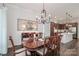 Elegant dining room features a chandelier, decorative wall art, and an open view to the kitchen at 6248 Raven Rock Dr, Denver, NC 28037