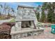 Outdoor stone fireplace on a patio with seating, perfect for gatherings at 6248 Raven Rock Dr, Denver, NC 28037