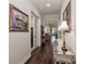 Inviting hallway with hardwood floors, tasteful decor, framed art, and views into multiple living spaces at 6248 Raven Rock Dr, Denver, NC 28037