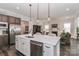 Open-concept kitchen featuring stainless steel appliances and a large center island with sink at 6248 Raven Rock Dr, Denver, NC 28037