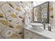 Stylish powder room with updated sink and floral wallpaper at 6328 County Donegal Ct, Charlotte, NC 28277