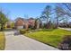 Brick home with attached two-car garage and landscaped yard at 6328 County Donegal Ct, Charlotte, NC 28277