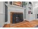 Brick fireplace with ornate screen, flanked by built-in shelving at 6328 County Donegal Ct, Charlotte, NC 28277