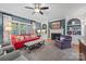 Cozy living room with fireplace, built-in shelving, and red sofa at 6328 County Donegal Ct, Charlotte, NC 28277