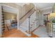 Elegant staircase with a white banister and carpeted steps at 6328 County Donegal Ct, Charlotte, NC 28277