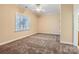 Bright bedroom with beige walls, carpet and window at 6926 Linkside Ct, Charlotte, NC 28277