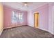 Spacious bedroom with pink walls, carpet, and window at 6926 Linkside Ct, Charlotte, NC 28277