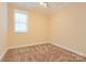 Simple bedroom with beige walls and brown carpet at 6926 Linkside Ct, Charlotte, NC 28277