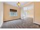 Bonus room with carpet, window and chandelier at 6926 Linkside Ct, Charlotte, NC 28277