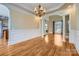 Formal dining room with hardwood floors, crown molding, and chandelier at 6926 Linkside Ct, Charlotte, NC 28277